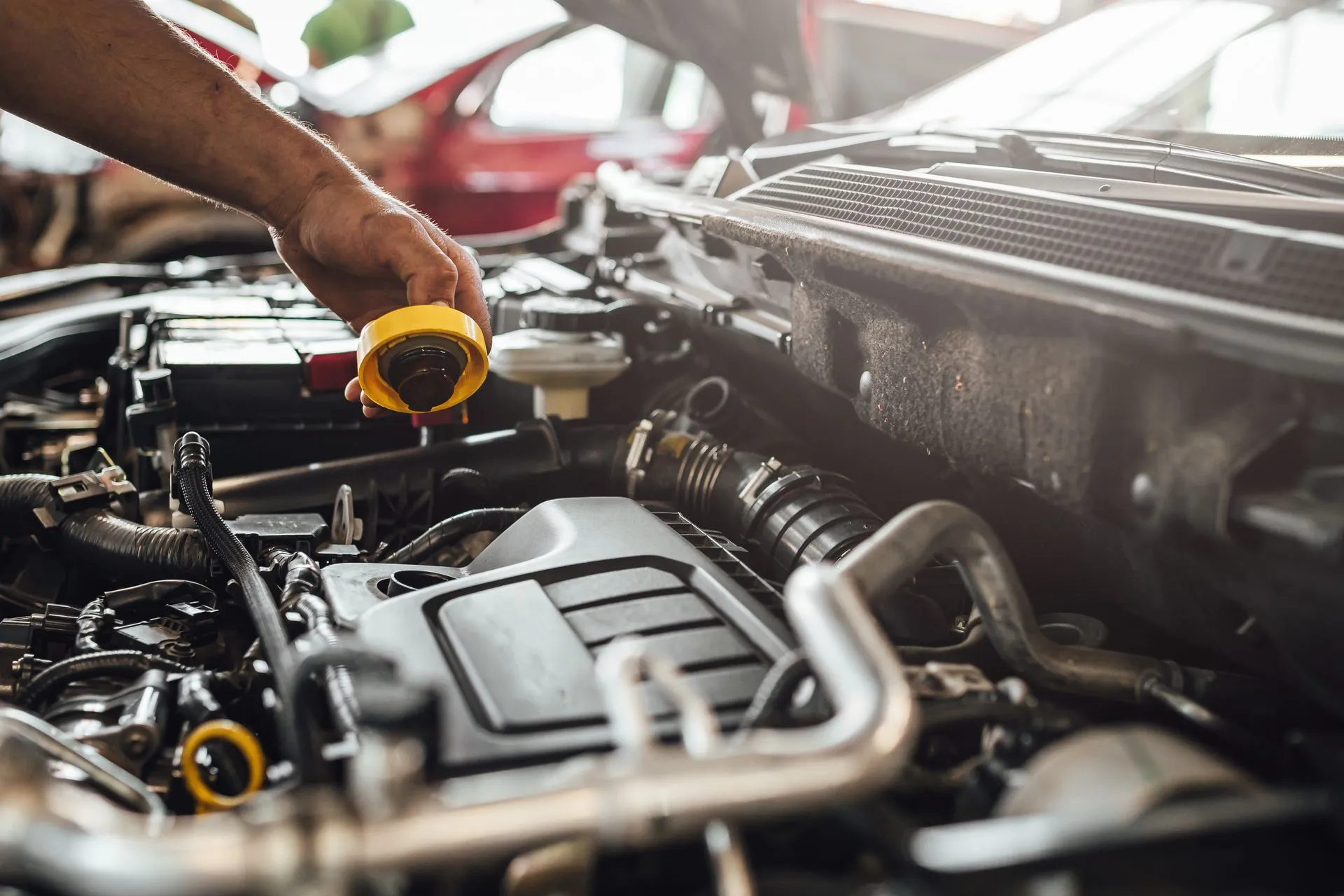 ASE-certified technician inspecting a car engine